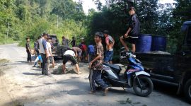 Surya Al Pajri dan warga Kecamatan Sukau berswadaya menambal jalan provinsi Liwa-OKU Selatan yang rusak parah pada April-Mei 2023. Foto: Haerul Abadi